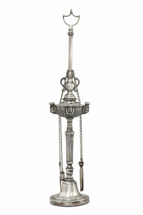 An oil lamp in molten, embossed and chiselled silver, Naples 19th century, guarantee stamp.