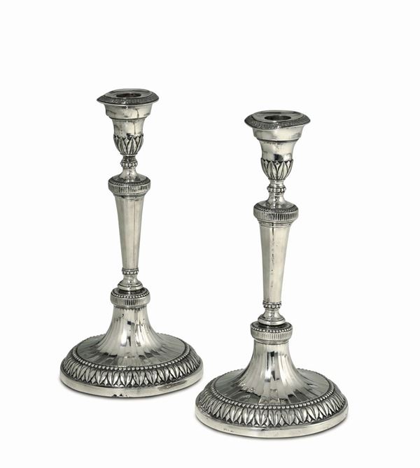 A pair of Directory candle holders in molten, embossed and chiselled silver. Genoa, Torretta stamp for the year 1796.