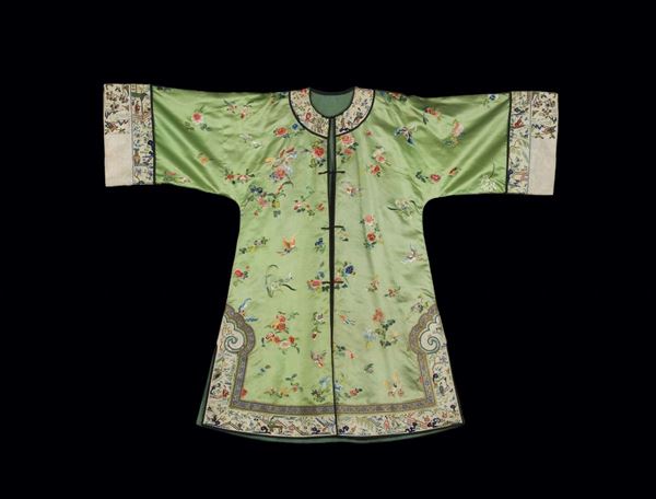 A grren-ground silk dress embroidered with naturalistic motif, China, early 20th century