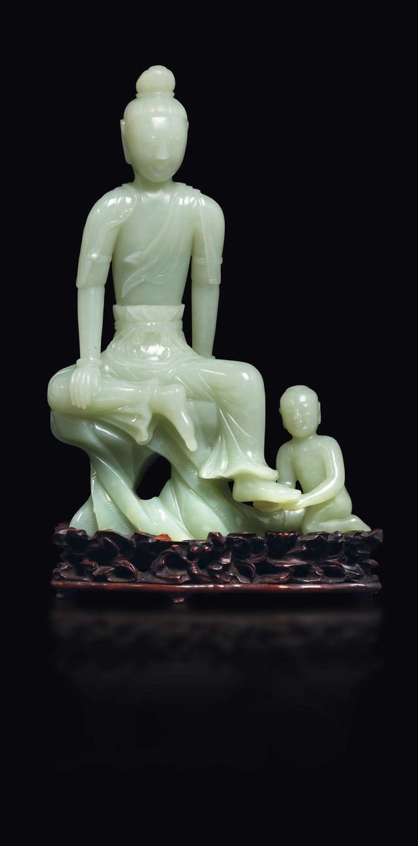 A white jade Buddha and child group, China, Qing Dynasty, 18th century