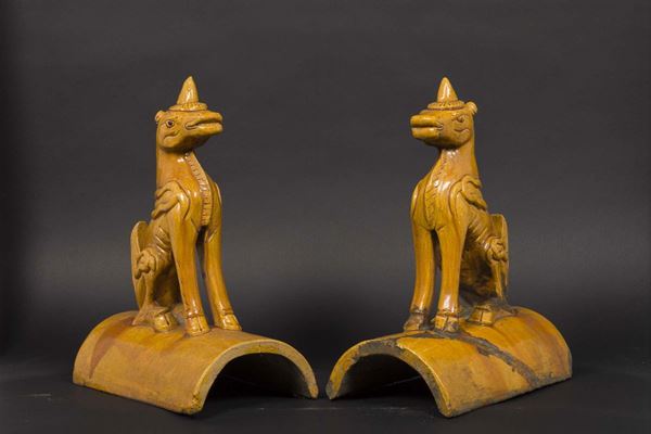 A pair of ochre glazed pottery shingles with fantastic animals, China, Ming Dynasty, 17th century