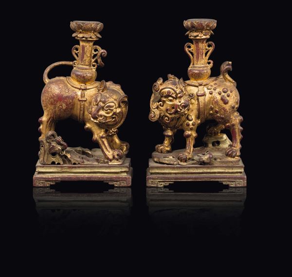 A pair of lacquered wood Pho dog candlesticks, China, Qing Dynasty, 18th century