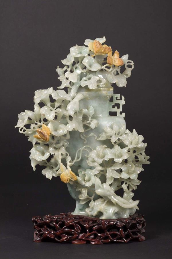 A green jade vase with naturalistic decoration in relief, China, Qing Dynasty, late 19th century