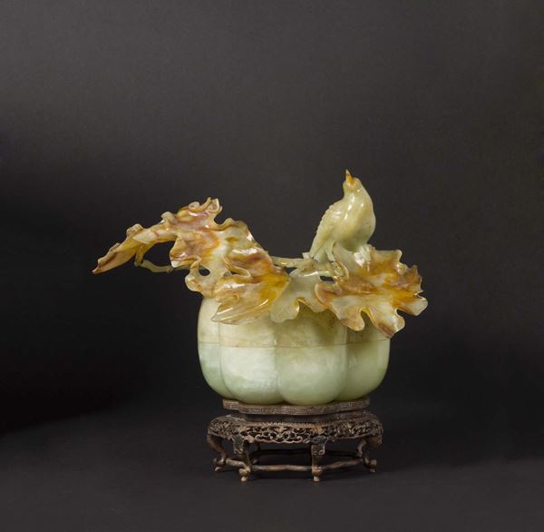 A yellow and russet jade box and cover with branch and bird in relief, China, early 20th century