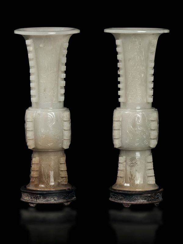A pair of white and russet jade archaic shape vases, China, Qing Dynasty, 19th century