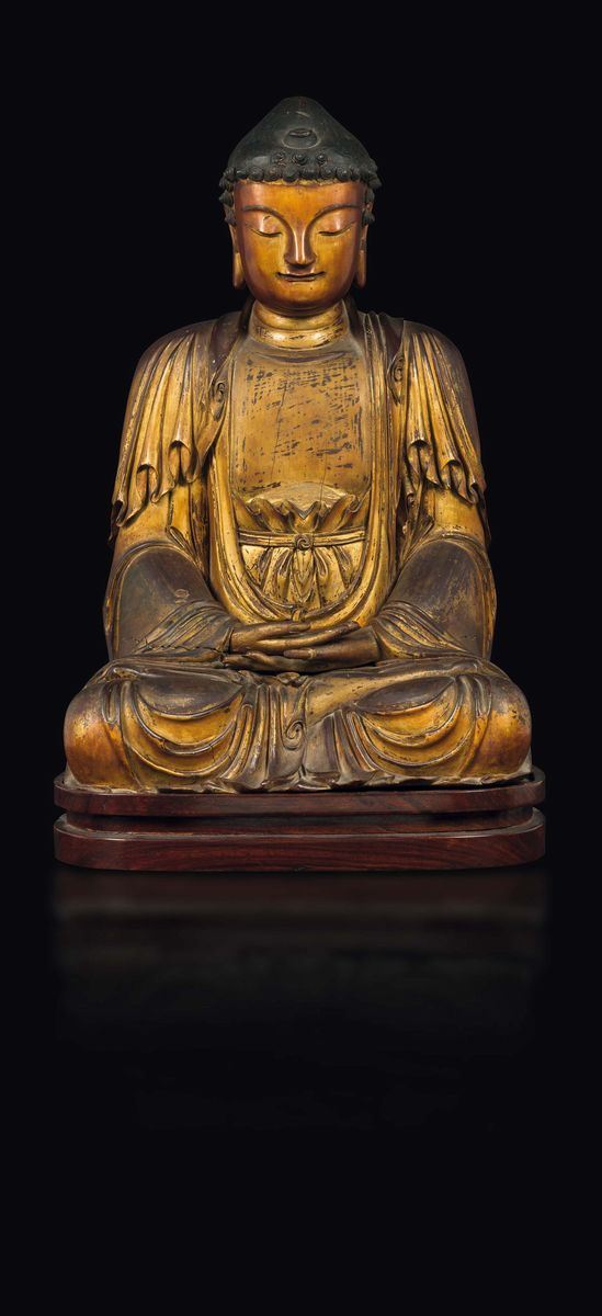 A gilt and lacquered wood figure of seated Buddha, China, Ming Dynasty, 16th century