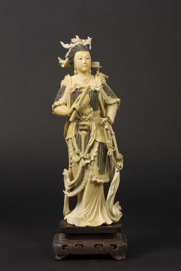 A carved ivory figure of Guanyin with a sword, China, early 20th century