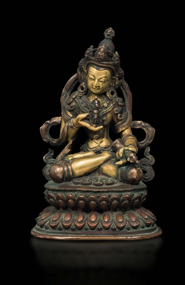 A burnished and gilt bronze figure of Amitayus with dorje on a double lotus flower, China, Ming Dynasty, 17th century