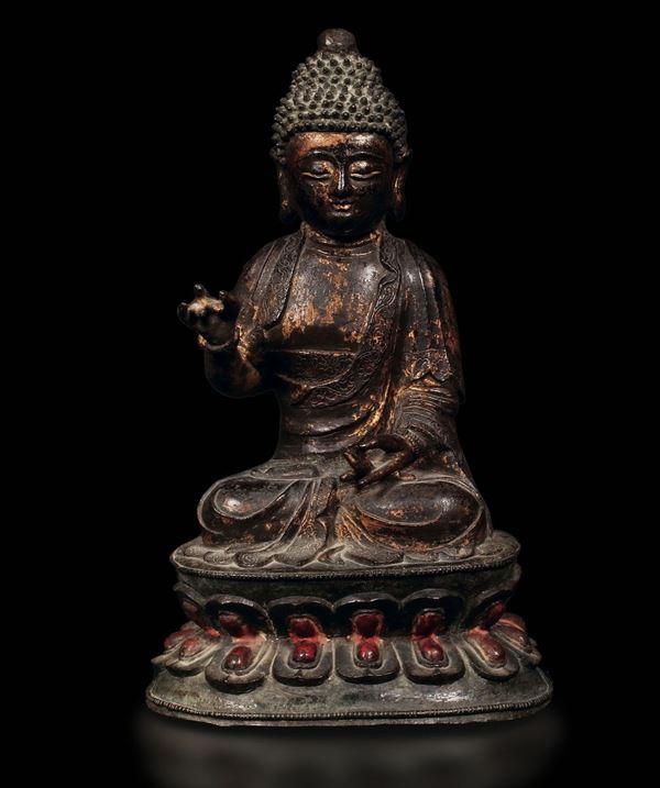 A semi-gilt bronze figure of Buddha on a double lotus flower, China, Ming Dynasty, 17th century