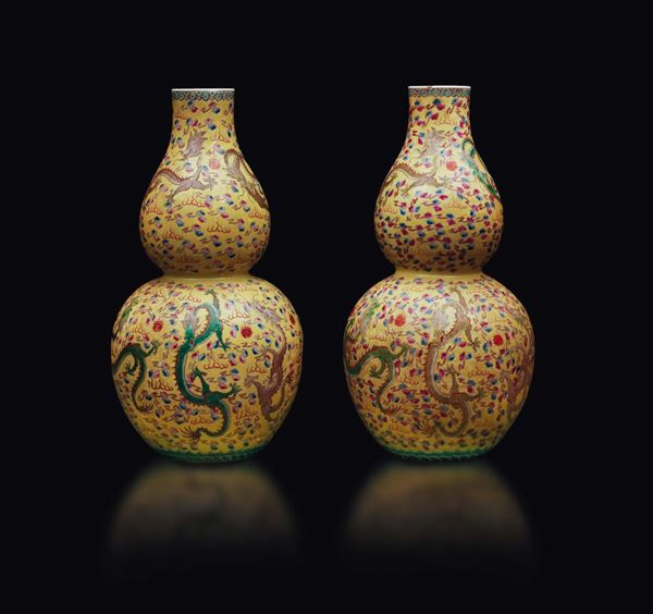 A pair of yellow-ground porcelain double-pumpkin vases with dragons between clouds, China, early 20th century