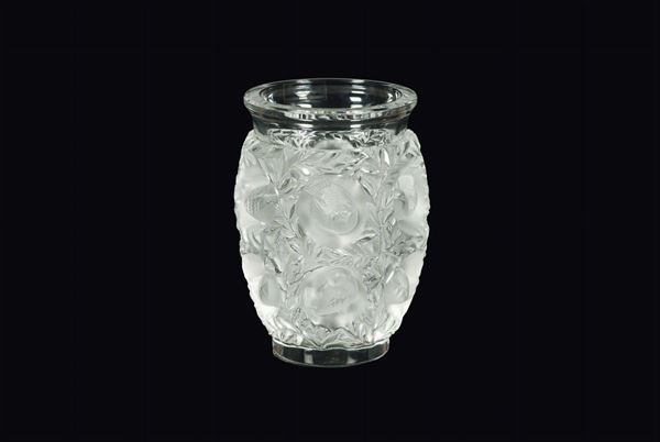 Lalique, France, 19th century. A crystal vase with a large sanded band with a decor of garlands and birds in relief