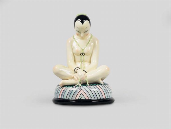 Lenci, Torino, 1930 ca. A figure of an Oriental character sitting in a yoga position, polychrome earthenware ceramics