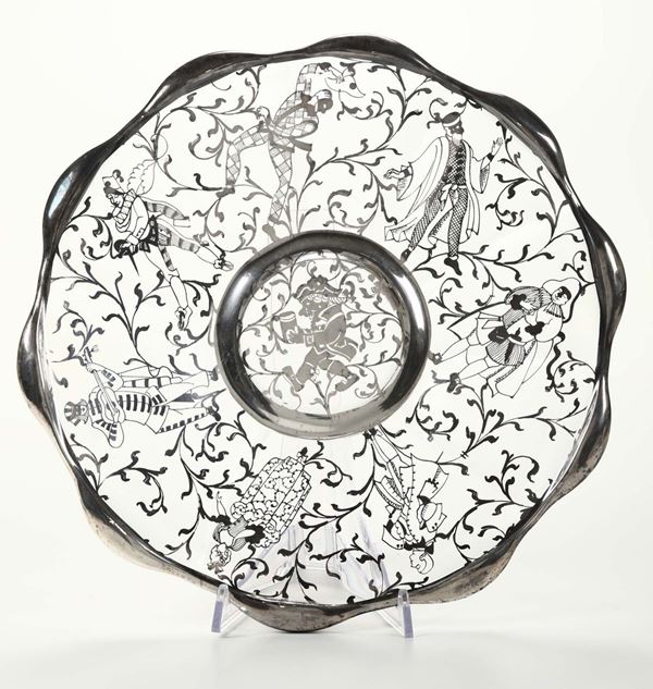 Piatto in cristallo decorato con maschere e bordo in argento