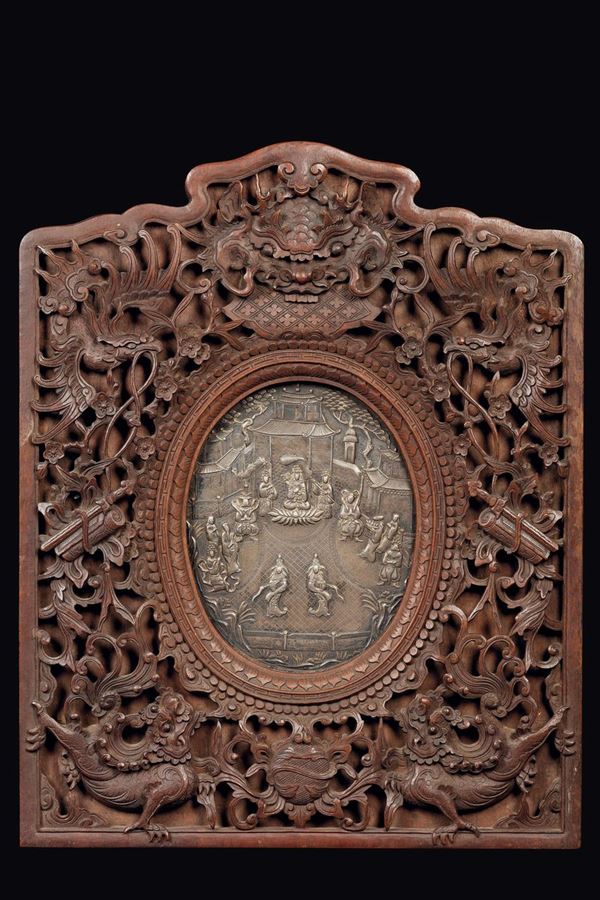 A carved wood panel and central silver medallion depicting a ceremony, China, 19th century