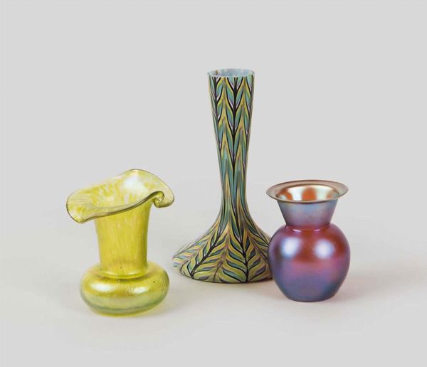 A lot made up by a small vase in iridescent green glass, Austria, early 1900s; a globular vase, VMF production, Austria; and a third vase in Phoenician style