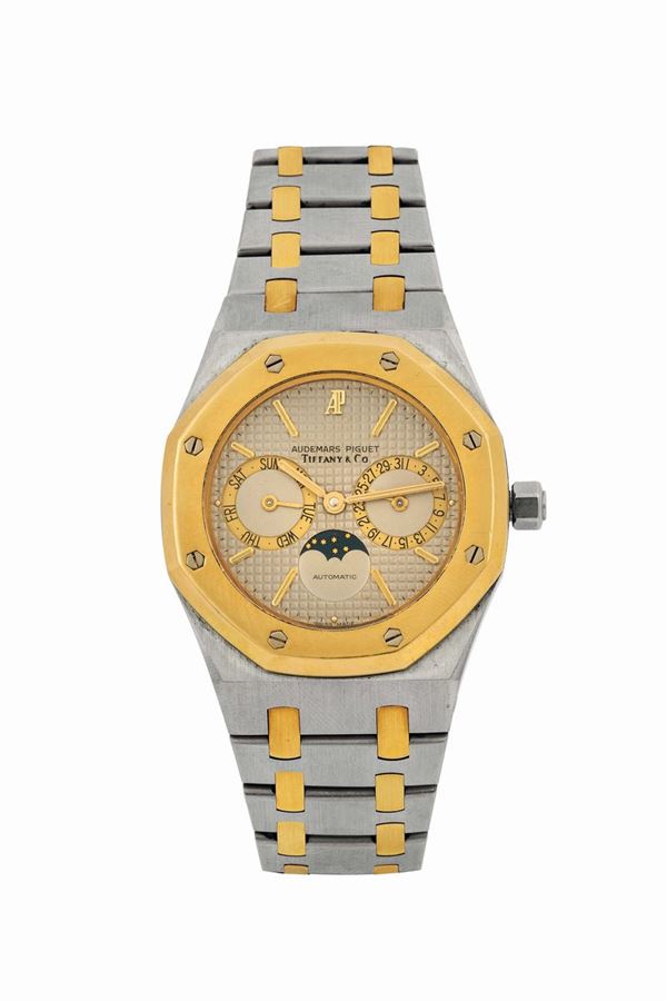 AUDEMARS PIGUET, ROYAL OAK, Dual- Time Automatic,  RETAILED BY TIFFANY ,No. 1280, Ref. 25594 SA. Very fine, octagonal, astronomic, self winding, water-resistant, 18k yellow gold and stainless steel wristwatch with day, date and moon phases and a 18K yellow gold and stainless steel Audemars Piguet bracelet with concealed deployant clasp. Accompanied by the original box, Guarantee and additional links. Made circa 1980