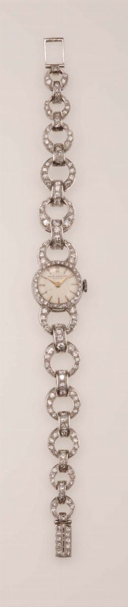 A lady's gold and diamond watch. Baume & Mercier