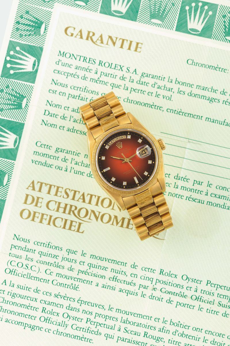 ROLEX, STELLA DEGRADE' DIAMOND VIGNETTE DIAL, Oyster Perpetual, Day-Date, Superlative Chronometer Officially Certified, case No.6727503,  Ref. 18078.  Fine and rare, tonneau-shaped, center seconds, self-winding, water- resistant, 18K yellow gold  wristwatch with day and date, Oxy blood dial, bark-finished bezel and an 18K yellow gold bark-finished President bracelet with concealed clasp. Accompanied by the Guarantee, additional link, original service paper. Made in 1981. Accompanied by the original box  - Auction Watches and Pocket Watches - Cambi Casa d'Aste