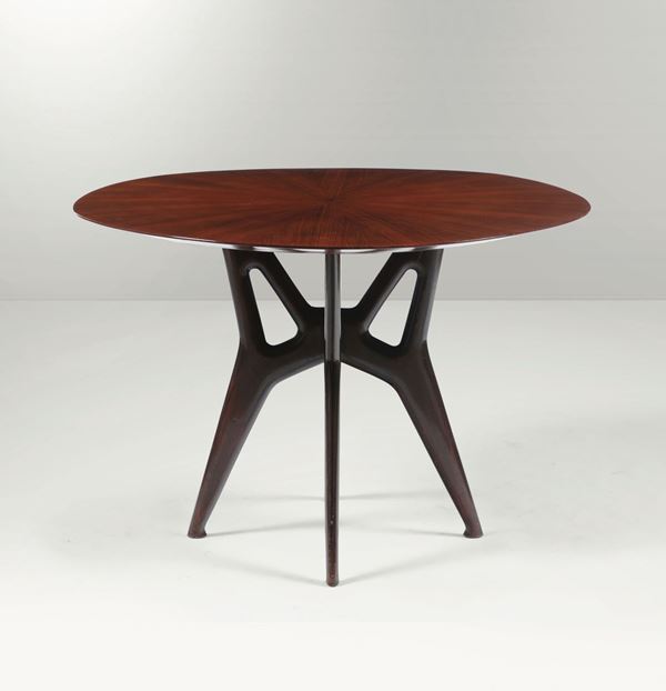 A table with an ebonised wood structure and a wooden top. Italy, 1950 ca.