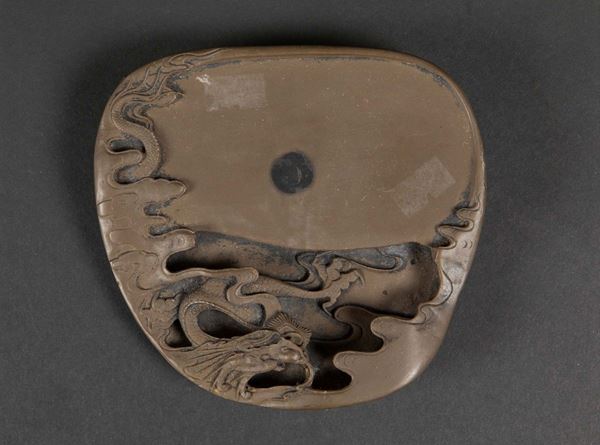 An inkstone depicting a dragon among the clouds and ideograms, China, Qing Dynasty, 19th century