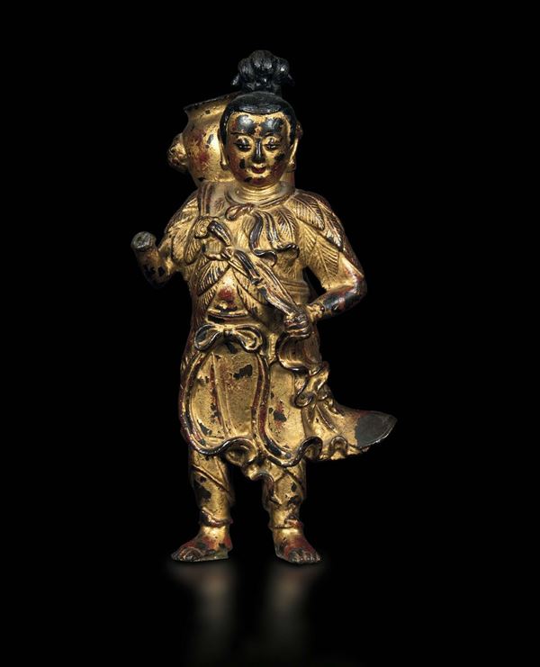 A gilt bronze figure of a man carrying a vase with traces of enamel, China, Ming Dynasty, 17th century