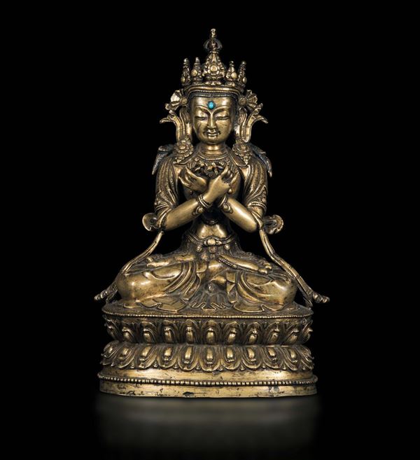 An important gilt bronze sculpture with a turquoise inlay depicting Vajradhara seated on a double lotus base, Central Tibet, Dorje Chang, 15th-16th century