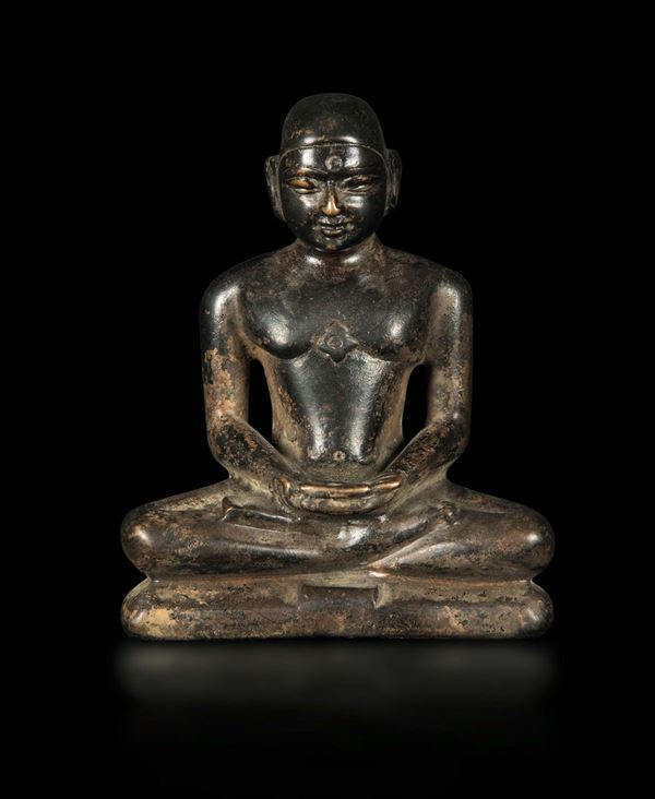 A semi-gilt bronze sculpture depicting a praying monk, Tibet, 19th century