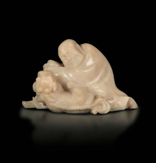 A small soapstone group with a figure of a wiseman and dog, China, Qing Dynasty, 19th century