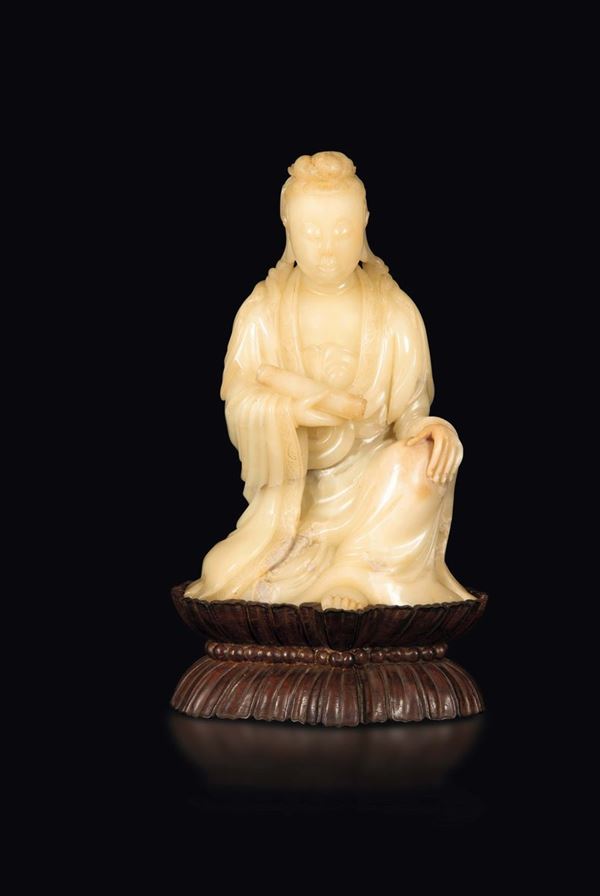 A soapstone group depicting a Guanyin with scroll, China, Qing Dynasty, 19th century