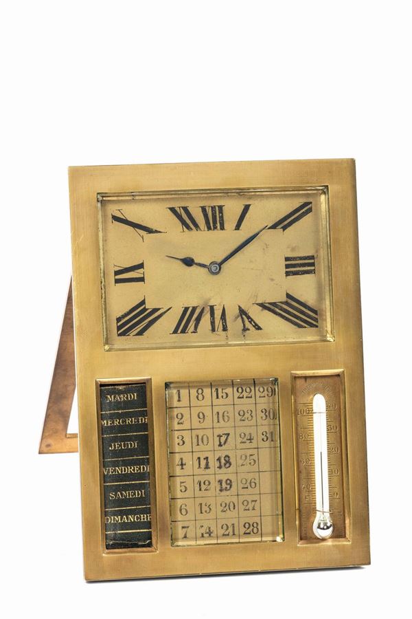 Unsigned. Fine, gilt brass table clock with calendar and thermometer. Made circa 1940