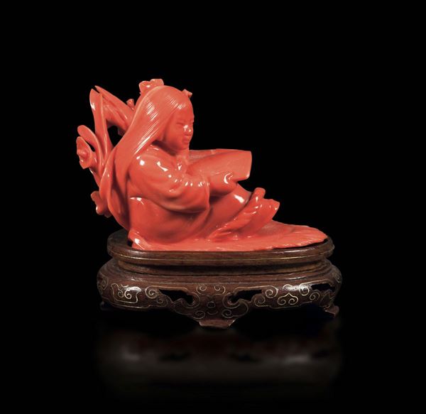 A small carved coral group depicting a girl with a book, China, early 20th century
