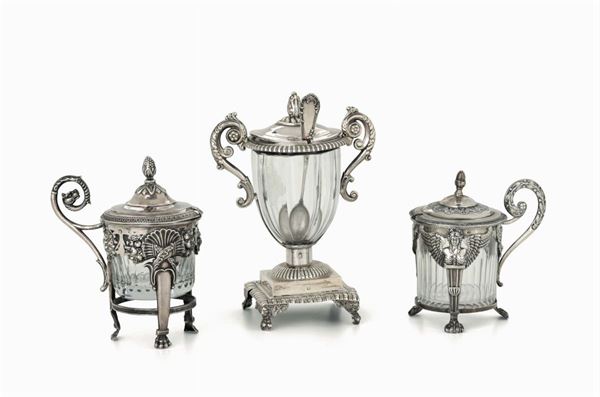 Tre mostardiere in argento fuso, sbalzato e cesellato,contenitori in vetro molato. Francia XIX-XX secolo