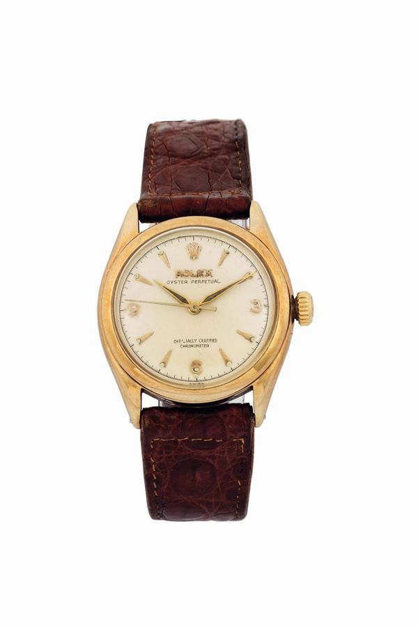 Rolex,  Oyster Perpetual  Officially Certified Chronometer,  Ref. 6084.  Fine and rare, tonneau-shaped, water resistant, center seconds, self-winding, 14K yellow gold wristwatch with a Rolex gold buckle. Made in the 1950 s. Accompanied by the original box