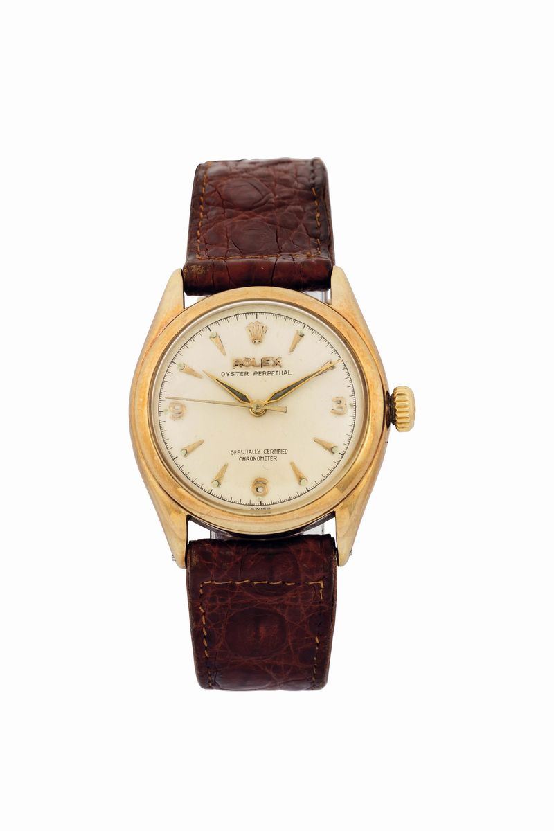 Rolex,  Oyster Perpetual  Officially Certified Chronometer,  Ref. 6084.  Fine and rare, tonneau-shaped, water resistant, center seconds, self-winding, 14K yellow gold wristwatch with a Rolex gold buckle. Made in the 1950 s. Accompanied by the original box  - Auction Watches and Pocket Watches - Cambi Casa d'Aste
