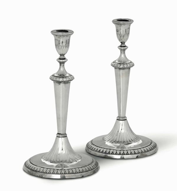 A pair of candlesticks in molten, embossed and chiselled silver. Tuscan manufacture, first quarter of the 19th century. French occupation mark and unidentified silversmith's mark