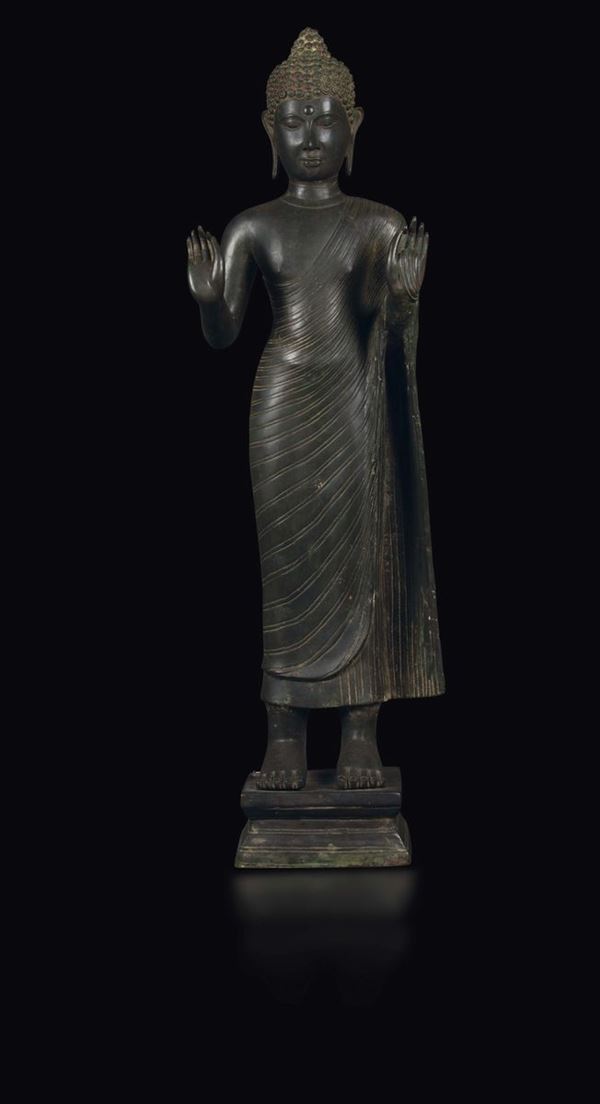 A copper sculpture of a standing Buddha, Thailand, 16th-17th century