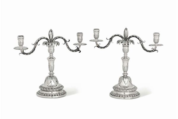 A pair of candlesticks in molten, embossed and chiselled silver, Genoa, Torretta stamp for 1778