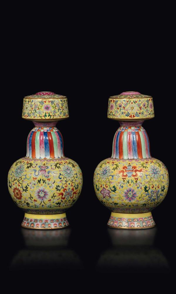 A pair of Pink Family porcelain vases with a baijixiang yellow backdrop and depictions of the eight Buddhist symbols, China, Republic, 20th century
