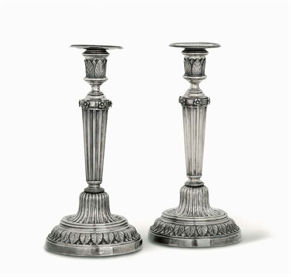 A pair of embossed and chiselled silver candlesticks, Bologna, late 18th century, rector's stamps (including Gaetano Babini (...1803-1839) and unidentified goldsmith's mark (Saint Dominic)