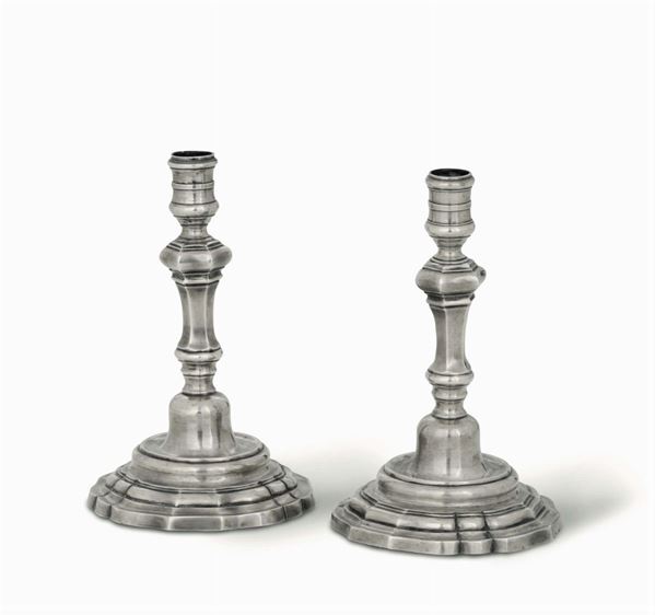 A pair of candlesticks in embossed and chiselled silver, Rome, 18th century, cameral stamp and another worn stamp