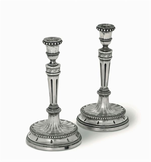 A pair of embossed and chiselled silver candlesticks, Rome, late 18th century, cameral stamps in use from 1797 to 1799 and worn silversmith's mark