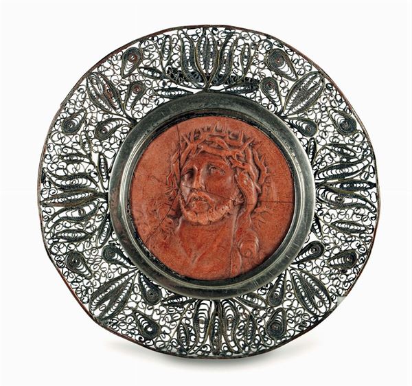 A Christ's head in coral material with a silver filigree frame, Sicily 19th century