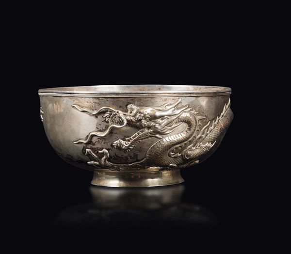 An embossed and chiselled silver bowl with a figure of a dragon, China, Qing Dynasty, 19th century
