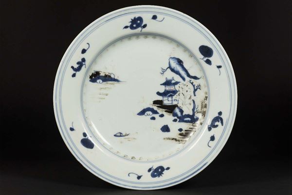 A porcelain plate depicting a landscape with a pagoda, blue with gold details, China, Qing Dynasty, Qianlong period (1736-1796)
