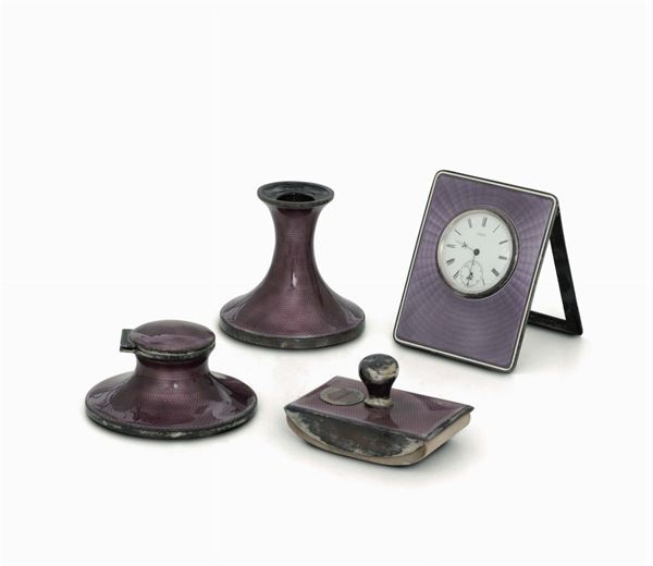 A writing desk set in silver and enamels made up by a pen holder, an inkwell and pad, Birmingham 1921 and a table clock in silver and Tiffany enamels, USA first half of the 20th century