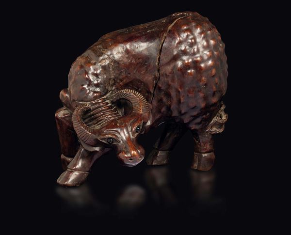 A carved wood buffalo with glass eyes, China, Qing Dynasty, 19th century