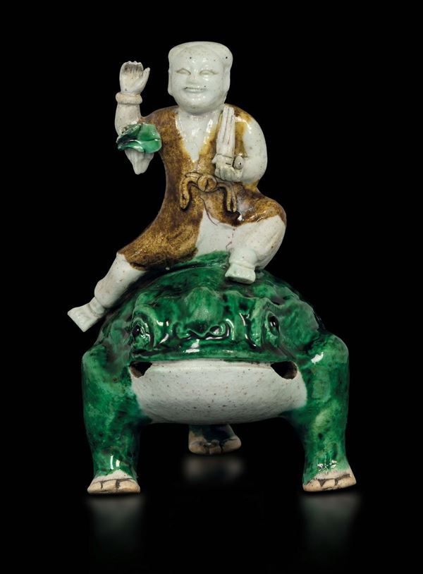 A sancai glazed porcelain figure of a child on a frog, China, Qing Dynasty, Kangxi period (1662-1722)