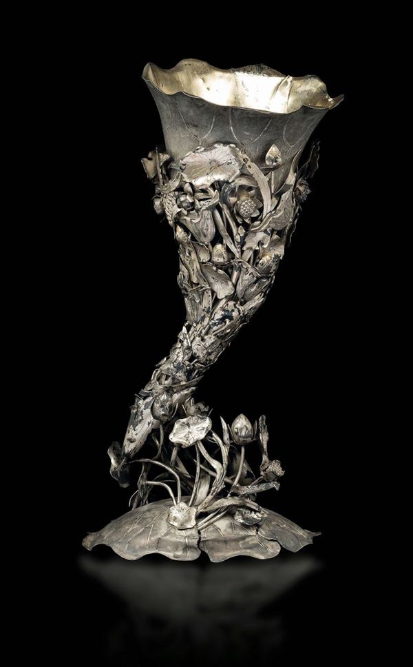 An embossed silver cornucopia in the shape of a rhino horn with a floral decor, China, Qing Dynasty, 19th century