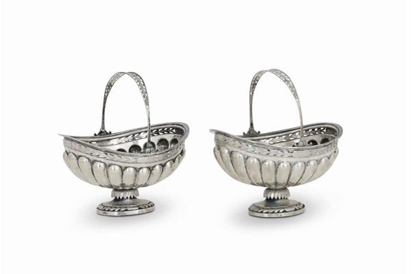 A pair of baskets with handle in molten, perforated and chiselled silver. Germany 20th century