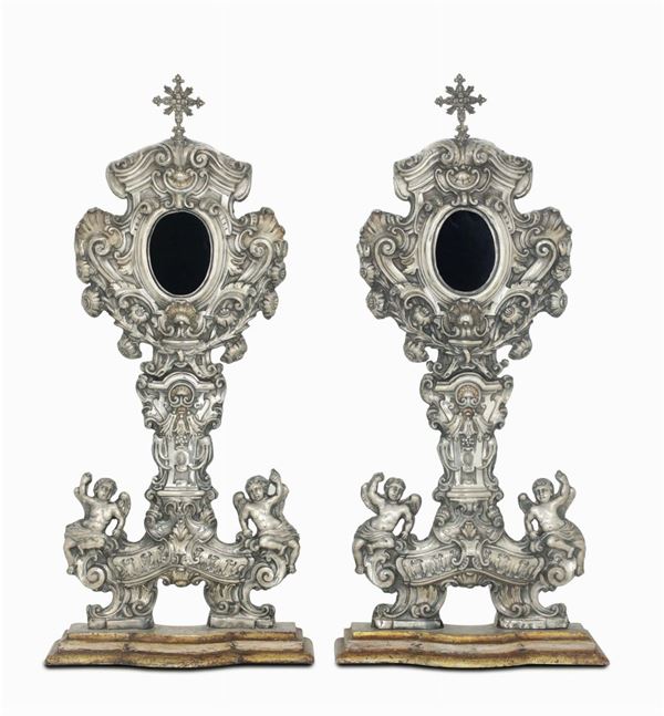 A pair of ostensory reliquiaries in embossed and chiselled silver. Naples, 1747, merchandise stamp with  [..]